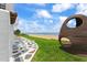 An egg chair sits on the lawn by the beach as viewed from the patio by the beach house at 201 Ocean Shore Blvd, Ormond Beach, FL 32176