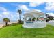 Charming gazebo on a grassy lawn with ocean views and built-in seating, perfect for relaxation at 201 Ocean Shore Blvd, Ormond Beach, FL 32176