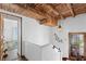 Elegant hallway showcasing wooden beams, unique lighting, and architectural details at 201 Ocean Shore Blvd, Ormond Beach, FL 32176