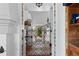 Hallway with a decorated archway that leads to the courtyard, showcasing beautiful tile work at 201 Ocean Shore Blvd, Ormond Beach, FL 32176