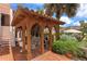 Relaxing outdoor patio with a wooden pergola, hammock and a view of the pool in the background at 201 Ocean Shore Blvd, Ormond Beach, FL 32176