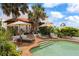 Relaxing pool area with lounge chairs, lush landscaping, and elegant architecture at 201 Ocean Shore Blvd, Ormond Beach, FL 32176