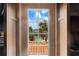 Inviting view from a window overlooking a refreshing pool and lush palm trees at 201 Ocean Shore Blvd, Ormond Beach, FL 32176