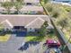 An aerial view of a home with lush landscape, a fence, and a driveway with parked cars at 202 Oakleigh Dr # 90, Deland, FL 32724