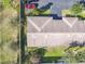 An aerial view of a home, showcasing the roof, lawn and nearby trees at 202 Oakleigh Dr # 90, Deland, FL 32724