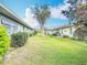 Spacious backyard with lush green grass and views of surrounding townhouses at 202 Oakleigh Dr # 90, Deland, FL 32724