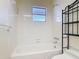 Bright bathroom featuring a tile-surrounded tub, modern fixtures, and storage space at 202 Oakleigh Dr # 90, Deland, FL 32724