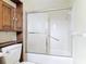 Bathroom featuring an enclosed shower-tub combo and extra storage space at 202 Oakleigh Dr # 90, Deland, FL 32724