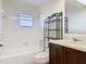 Bathroom showcasing a tile-surrounded tub, modern fixtures, and a spacious vanity at 202 Oakleigh Dr # 90, Deland, FL 32724
