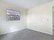 Simple bedroom with light walls and gray carpet, featuring a sunlit window at 202 Oakleigh Dr # 90, Deland, FL 32724