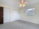 Light-filled bedroom with plush carpet, closets, and a ceiling fan at 202 Oakleigh Dr # 90, Deland, FL 32724