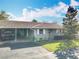 Charming single-story home featuring a covered carport, well-maintained lawn, and inviting curb appeal at 202 Oakleigh Dr # 90, Deland, FL 32724