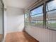 Relaxing sunroom with tile flooring, textured walls, and large sunlit windows at 202 Oakleigh Dr # 90, Deland, FL 32724
