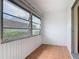 Bright sunroom with tile flooring and large windows offering outdoor views at 202 Oakleigh Dr # 90, Deland, FL 32724