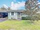 Charming single-story home featuring a well-maintained lawn and mature landscaping at 202 Oakleigh Dr # 90, Deland, FL 32724