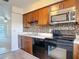 Updated kitchen with wood cabinets, stainless steel appliances, and a modern tile backsplash at 202 Oakleigh Dr # 90, Deland, FL 32724