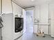 Bright laundry room with a white Maytag washer and dryer, and ample storage space at 202 Oakleigh Dr # 90, Deland, FL 32724