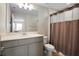 Well-lit bathroom with a vanity, toilet, and a shower with a curtain at 206 Beautyberry Ln, Sanford, FL 32771