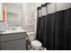 This well-lit bathroom features a vanity, toilet, and a shower with a curtain at 206 Beautyberry Ln, Sanford, FL 32771