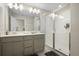 Beautiful bathroom with double vanity, a large mirror, and glass enclosed shower at 206 Beautyberry Ln, Sanford, FL 32771