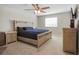 This cozy bedroom features a large window, a ceiling fan, and neutral tones at 206 Beautyberry Ln, Sanford, FL 32771