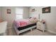 Lovely bedroom decorated with a twin bed, window, and small nightstand at 206 Beautyberry Ln, Sanford, FL 32771