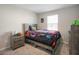 Comfortable bedroom with a twin-sized bed and a dresser with natural lighting at 206 Beautyberry Ln, Sanford, FL 32771
