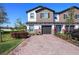 Charming townhome featuring brick paver driveway and manicured landscaping at 206 Beautyberry Ln, Sanford, FL 32771