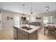 Open kitchen, featuring a large island, breakfast bar, and modern lighting at 206 Beautyberry Ln, Sanford, FL 32771