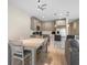 Bright kitchen features stainless steel appliances, pendant lighting, and a dining area with wood floors at 206 Beautyberry Ln, Sanford, FL 32771