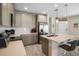 Open kitchen with stainless appliances, eat-in island, and pendant lighting at 206 Beautyberry Ln, Sanford, FL 32771