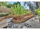 Backyard with mature foliage and manicured garden bed at 230 White Dove Ave, Orange City, FL 32763