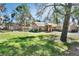 Spacious backyard with mature trees providing ample shade, perfect for outdoor activities at 230 White Dove Ave, Orange City, FL 32763