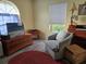 Cozy bedroom showcasing a comfortable sitting area with natural light and charming decor at 230 White Dove Ave, Orange City, FL 32763
