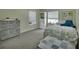 Comfortable bedroom with wood floors, neutral walls, and a view to a window at 230 White Dove Ave, Orange City, FL 32763