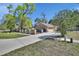 Exterior view of home with a brick facade, attached garage and well-manicured lawn at 230 White Dove Ave, Orange City, FL 32763