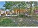 Charming brick outbuilding surrounded by flowers and mature foliage at 230 White Dove Ave, Orange City, FL 32763