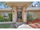 Close-up of the home's entry, highlighting the brick facade and covered porch at 230 White Dove Ave, Orange City, FL 32763