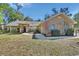 Charming brick home featuring a well-maintained yard and inviting entrance at 230 White Dove Ave, Orange City, FL 32763