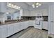 Bright kitchen featuring white cabinets, granite counters, tile backsplash, and stainless steel appliances at 230 White Dove Ave, Orange City, FL 32763