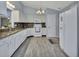 Bright kitchen featuring white cabinets, granite counters, tile backsplash, and stainless steel appliances at 230 White Dove Ave, Orange City, FL 32763