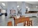 Open-concept living room with hardwood floors connecting to the kitchen, creating a perfect entertaining space at 230 White Dove Ave, Orange City, FL 32763