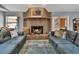 Living room featuring a brick fireplace, comfortable sofas, and natural light at 230 White Dove Ave, Orange City, FL 32763
