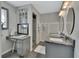 Bathroom featuring dual sinks, granite countertops, modern lighting, and a glass-enclosed shower at 230 White Dove Ave, Orange City, FL 32763