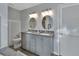Bathroom featuring dual sinks, granite countertops, modern lighting, updated fixtures and toilet at 230 White Dove Ave, Orange City, FL 32763