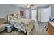 Comfortable bedroom with wood floors, neutral walls, ceiling fan, and a large window for natural light at 230 White Dove Ave, Orange City, FL 32763