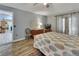 Cozy bedroom with wood floors, neutral walls, ceiling fan, private outdoor access, and connected to another room at 230 White Dove Ave, Orange City, FL 32763