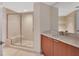 Bathroom features a glass shower, vanity and marble countertops at 231 Riverside Dr # 1801-1, Daytona Beach, FL 32117