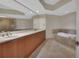 Bathroom featuring double sinks, a soaking tub, and a seamless glass shower at 231 Riverside Dr # 1801-1, Daytona Beach, FL 32117