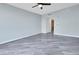 Spacious bedroom with a ceiling fan and sleek gray flooring at 231 Riverside Dr # 1801-1, Daytona Beach, FL 32117